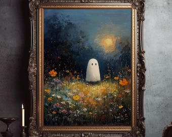 May include: An oil painting in an ornate gold frame shows a ghost in a wildflower meadow under a moon. The frame rests on a wooden table with books, a candle, and decorative items. The artwork has a whimsical, spooky theme.