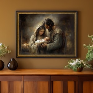 May include: A framed painting depicts a tender scene of the Holy Family. Mary and Joseph gaze lovingly at the baby Jesus, cradled in a manger. The artwork features soft colors and a warm, inviting atmosphere, perfect for religious home decor.