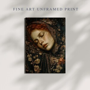 May include: Fine art print featuring a portrait of a woman with red hair, eyes closed, and a serene expression. She is adorned with a dark, ornate head covering and surrounded by floral details. The print is unframed.
