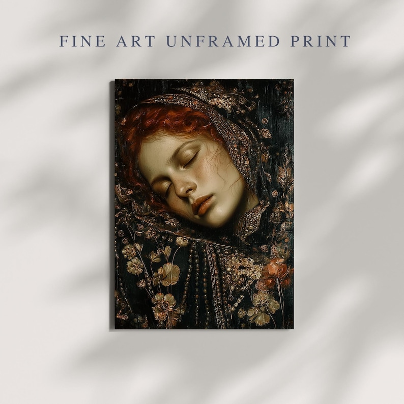 May include: Fine art print featuring a portrait of a woman with red hair, eyes closed, and a serene expression. She is adorned with a dark, ornate head covering and surrounded by floral details. The print is unframed.