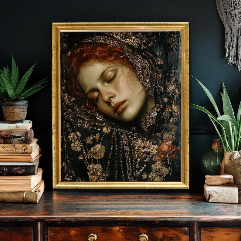 May include: A framed portrait of a woman with red hair, eyes closed, in a gold frame. The artwork features a dark background with floral and ornamental details. The woman is wearing a dark garment with gold embellishments.