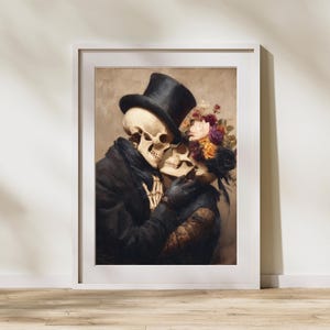 May include: A framed art print featuring a skeletal couple embracing. The male figure wears a black top hat and coat, while the female figure has a floral headpiece. The artwork has a vintage, romantic theme with a neutral color palette.