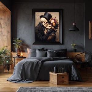 May include: A framed artwork depicts two skeletons embracing, one wearing a top hat and the other adorned with flowers. The artwork hangs above a bed with gray bedding, complemented by a wooden nightstand and a black pendant light.