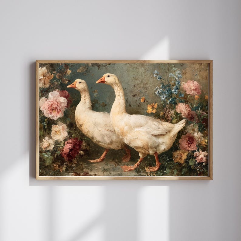 May include: A framed art print featuring two white geese with orange beaks and feet, set against a backdrop of colorful flowers. The artwork has a vintage aesthetic, with soft lighting and a muted color palette.