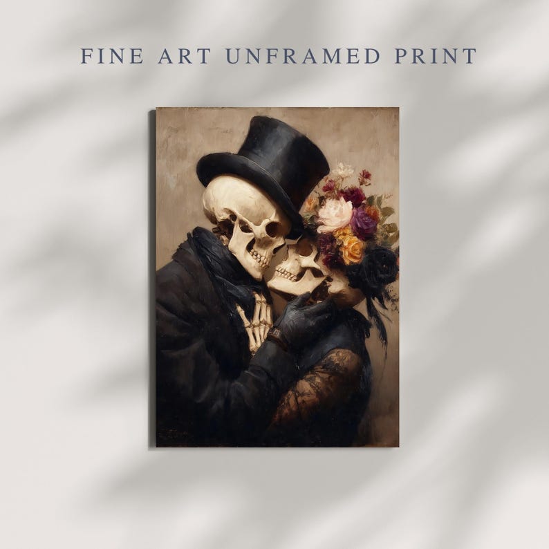 May include: Fine art print featuring a romantic embrace between two skeletons. One skeleton wears a black top hat and coat, while the other is adorned with flowers. The artwork has a vintage aesthetic and the text "FINE ART UNFRAMED PRINT" is at the top.