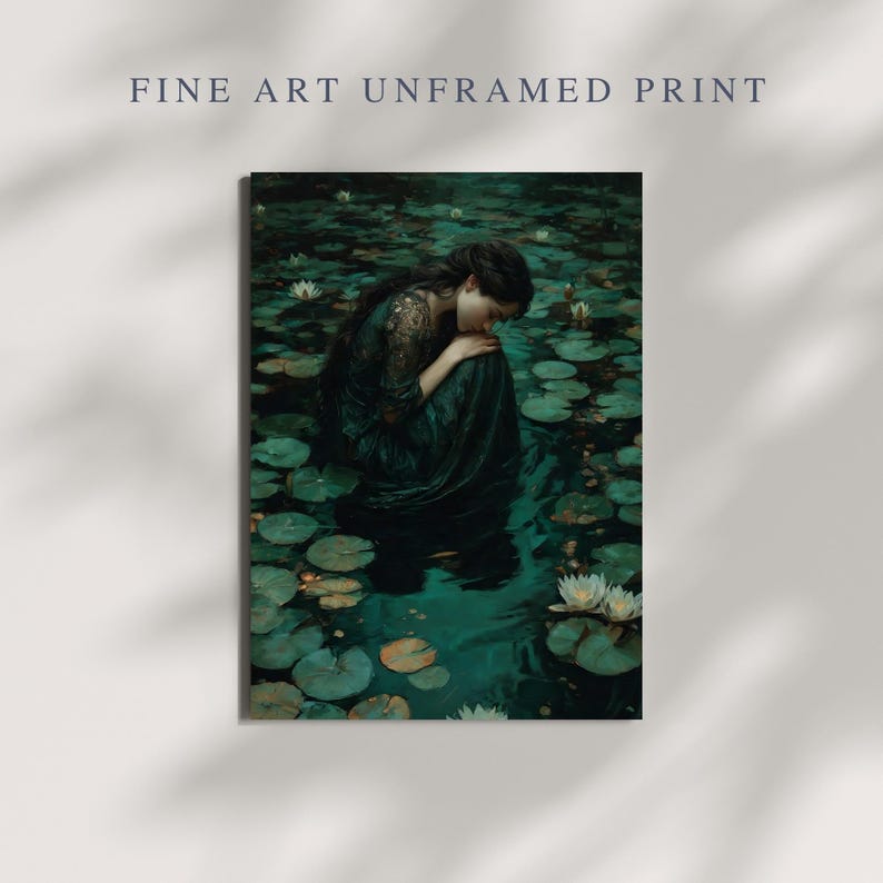 May include: Fine art print featuring a woman in a dark green dress, seated in a pond filled with lily pads and white flowers. The image has a moody, artistic feel, with the text "FINE ART UNFRAMED PRINT" at the top.