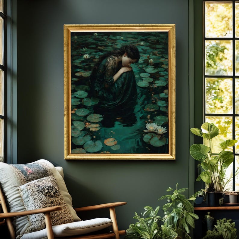 May include: A framed painting depicts a person in a dark green dress, seated in a pond filled with lily pads and white water lilies. The artwork has a gold frame and is displayed on a dark green wall. The scene evokes a sense of tranquility.