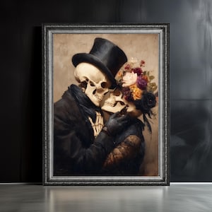 May include: A framed artwork depicts two skeletons embracing. One skeleton wears a black top hat and coat, the other a floral headpiece and black gloves. The artwork has a dark, romantic theme with a vintage aesthetic.