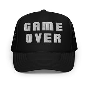 May include: Black trucker hat with the words "GAME OVER" embroidered in white block letters. The hat has a curved brim and a mesh back for breathability. A casual accessory for gamers.