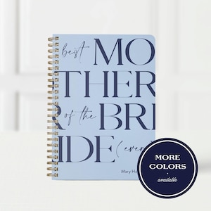 May include: A light blue spiral-bound notebook with dark blue text that reads best MOTHER of the BRIDE (ever) and Mary Ha. A dark blue circular badge in the bottom right corner features the white text MORE COLORS available.