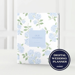 May include: A wedding planner with a white cover featuring a blue hydrangea floral pattern. The planner has a light blue square with the words "OUR WEDDING" and the names "Lily and Mason". A circular graphic reads "DIGITAL WEDDING PLANNER included".