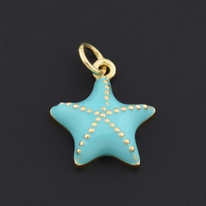 May include: A turquoise starfish charm with gold-coloured trim and dotted accents. The charm has a small gold loop at the top for attaching to a necklace or bracelet. The background is a solid black.