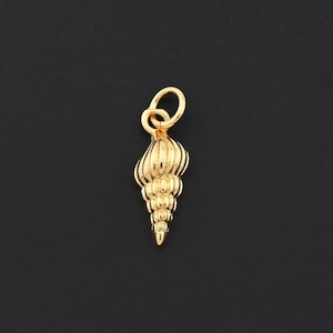 May include: A gold-colored seashell charm with a spiral design. The charm has a loop at the top for attaching to a necklace or bracelet. The seashell charm is a jewelry component.