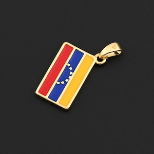 May include: Gold-coloured pendant featuring the flag of Venezuela. The rectangular pendant has a red stripe, a blue stripe with white stars, and a yellow stripe. The pendant is suspended from a gold bail.