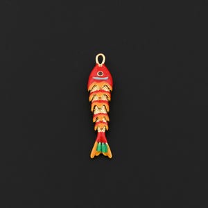 May include: A fish-shaped pendant featuring a vibrant red and orange enamel finish with gold-toned textured scales. The design includes a small loop at the top for hanging, a single dark eye, and a light blue mouth detail with green tail accents.