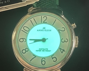 Anne Klein Instalite Ladies Green Textured Leather Band Silver Case Mother of Pearl Dial Arabic Numerals Water Resist Glowing Backlight