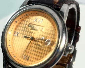 Cross W#35 Watch Features Rose Gold Textured Dial Roman Numerals Circular Date Window Silver Case Brown Leather Strap Quartz Movement