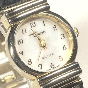 vintage Yves Saint Laurent (YSL) quartz watch. Round, two-tone (gold and silver) case, integrated bracelet striking abalone shell inserts.