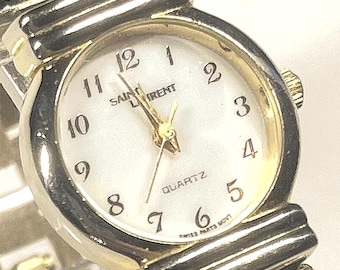 vintage Yves Saint Laurent (YSL) quartz watch. Round, two-tone (gold and silver) case, integrated bracelet striking abalone shell inserts.