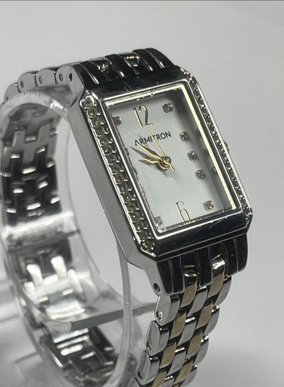 A rectangular Armitron two-tone watch with a whit… - image 1