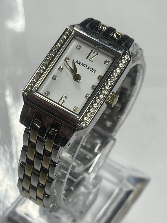 A rectangular Armitron two-tone watch with a whit… - image 2
