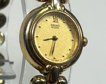 Seiko Quartz 19mm Round Gold Plated Ladies' Cocktail watch with New Battery. distinct "pebble" or fancy link-style bracelet Circa 1979*