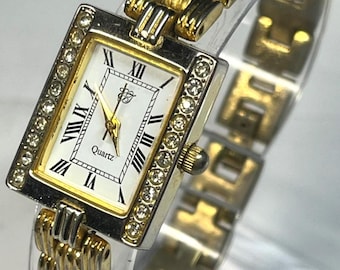 Elizabeth Taylor Tank watch 90s vintage gold tone rhinestone bezel white dial quartz movement classic design collectible item. new battery.