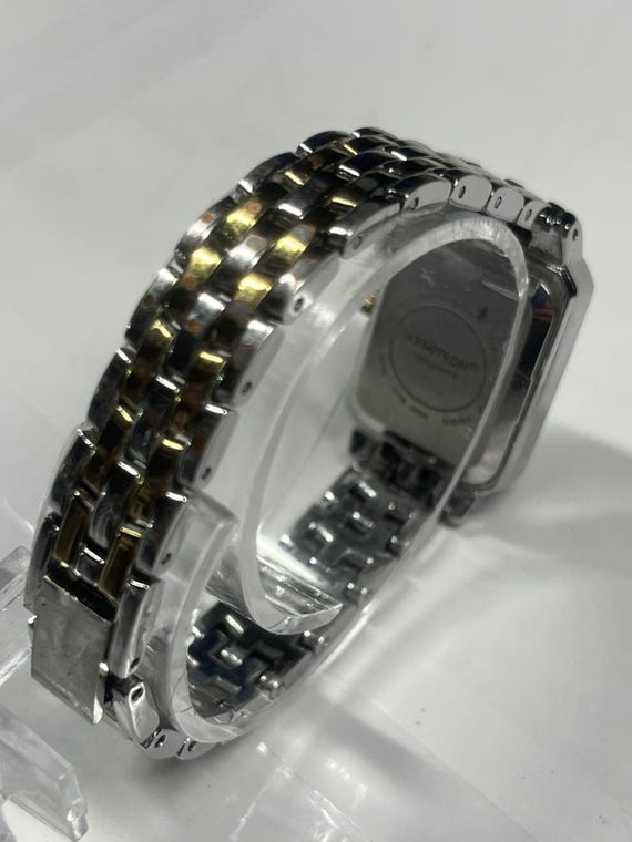 A rectangular Armitron two-tone watch with a whit… - image 8