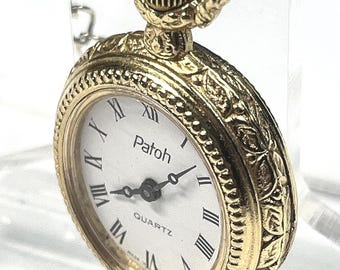 Patoh Quartz pocket watch gold tone engraved case quartz movement classic design accurate timekeeping vintage enamel back. 22mm x 26mm