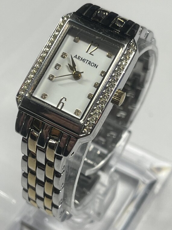 A rectangular Armitron two-tone watch with a whit… - image 4