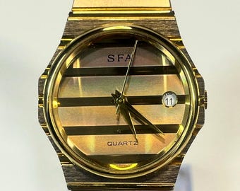 Vintage SFA (Saks Fifth Avenue) quartz classic. direct homage to the high-end luxury aesthetic pioneered by the Piaget Polo, New Battery