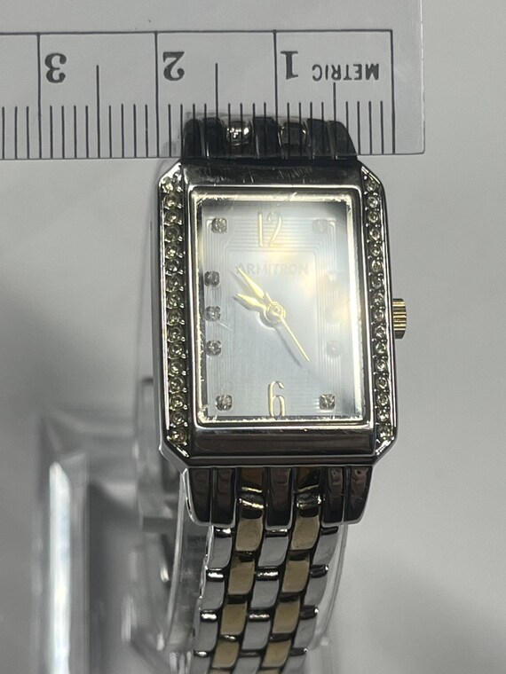 A rectangular Armitron two-tone watch with a whit… - image 6
