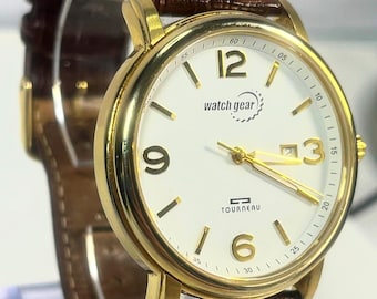 Watchgear by Tourneau. Luxury Swiss Gold Tone Matte dress watch, Brown Leather Strap. New Battery. Hard shell case.