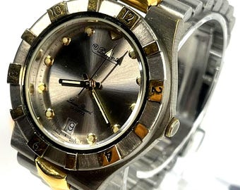 Dufonte by Lucien Piccard two-tone quartz diver-style watch. grey sunburst dial with gold-tone hour markers, New Battery
