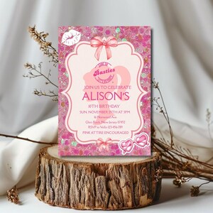 May include: A pink invitation card with glitter accents, featuring the text "Join us to celebrate Alison's 10th Birthday." The card includes a bow, heart-shaped sunglasses, and a lip illustration. The invitation is displayed on a wooden base.