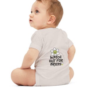 Two-sided Onesie with A Dink A Day Smiling Flower brand on the front and &quot;Watch Out for Drops&quot; on the back