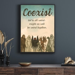 May include: A framed art print with the word "Coexist" and the phrase "We're all weird - might as well be weird together." The artwork features illustrations of various mythical creatures in a row, set against a sky-blue background.