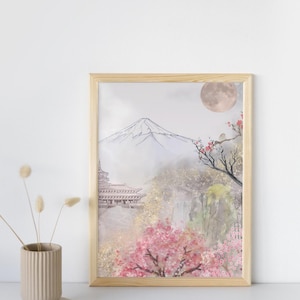 以下が含まれることがあります： 日本の風景を描いた、木製のフレームに入った水彩画プリント。富士山、塔、桜、満月が描かれています。ピンク、緑、グレーの色合いが特徴です。