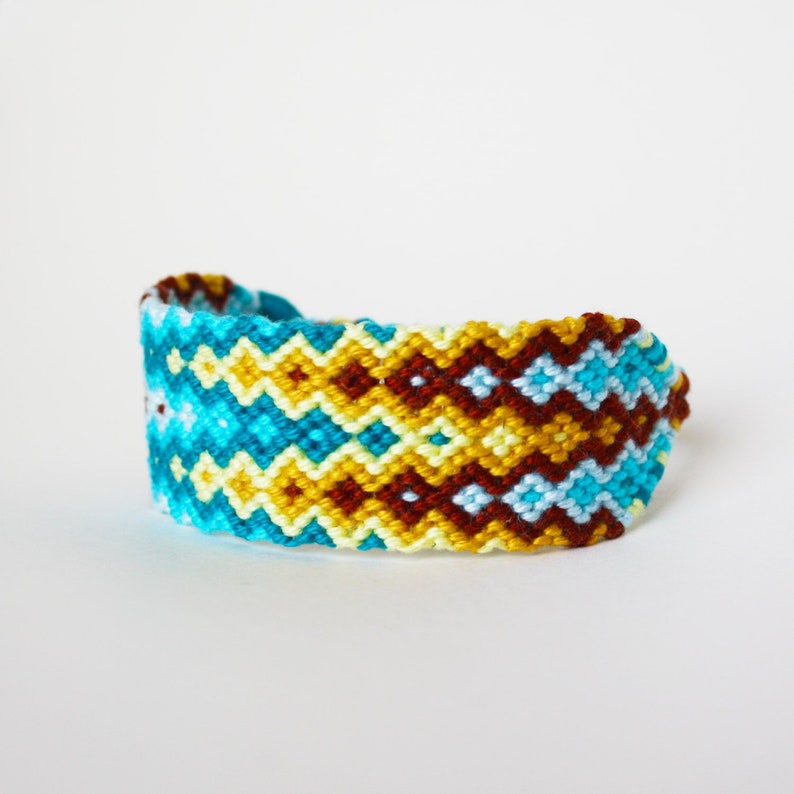 Friendship bracelet macram\u00e9 Boho statement cuff geometric double waterfall pattern design blue brightly colored ripple zigzag beach
