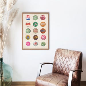 May include: A framed print of vintage soda bottle caps. The print features 16 different bottle caps with various brand names and logos, including Coca-Cola, Sprite, Dr Pepper, 7 Up, Mountain Dew, and others.
