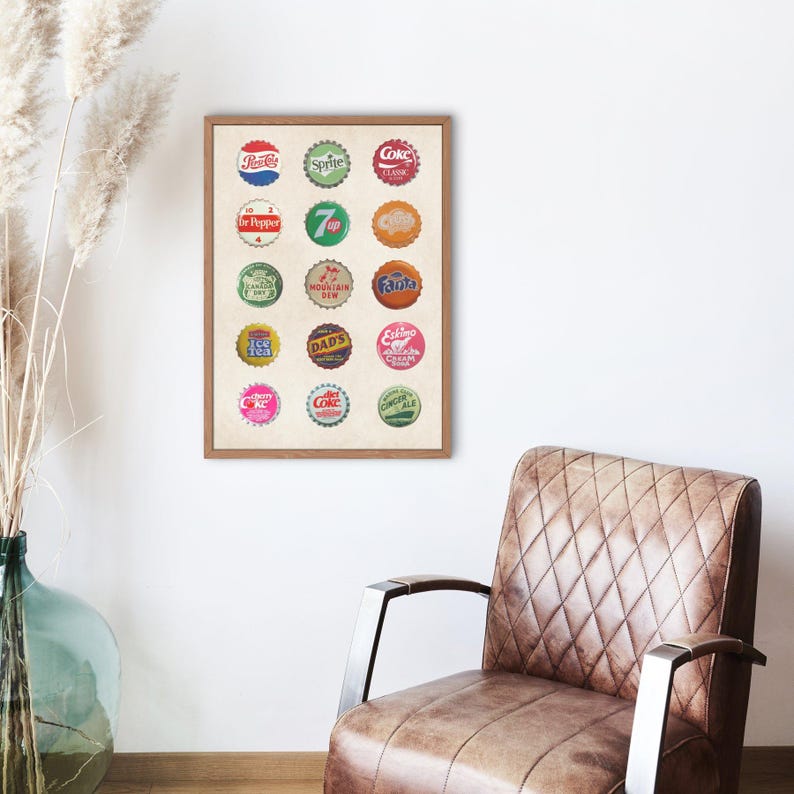May include: A framed print of vintage soda bottle caps. The print features 16 different bottle caps with various brand names and logos, including Coca-Cola, Sprite, Dr Pepper, 7 Up, Mountain Dew, and others.