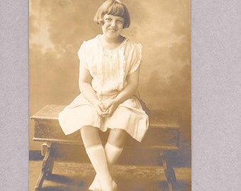 Vintage Photo of a Girl on a Bench circa 1920s in Sepia