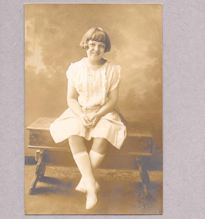 Vintage Photo of a Girl on a Bench circa 1920s in Sepia image 1
