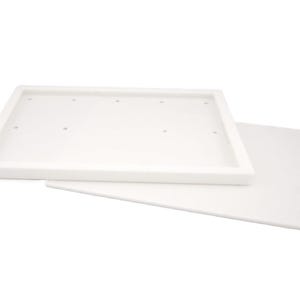 May include: A white rectangular tray with a raised border and six small holes, paired with a flat, white rectangular piece. The items are made of a solid, opaque material and are set against a white background.