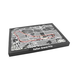 May include: A framed, grayscale map of the Italian Grand Prix race track, with a red track outline. The frame is black, and the text "Italian Grand Prix" is displayed on a black label at the bottom.