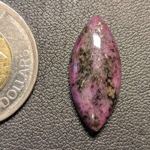 Puede incluir: Un juego de tres tazas de cerámica con un esmalte moteado de color crema. Cada taza presenta un diseño pintado a mano diferente: una hoja azul y verde, una flor amarilla y una baya roja. Las tazas tienen un diseño sencillo y moderno.