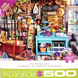May include: A 500-piece jigsaw puzzle featuring a detailed illustration of a potting shed. The image includes gardening tools, flowers, and a blue potting table. The puzzle box has the text "The Potting Shed" and "Eurographics Puzzle".