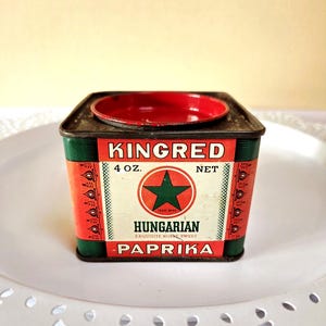 May include: Vintage Kingred Hungarian Paprika tin. The tin is red and green with the words "KINGRED" and "PAPRIKA" in white. A green star is in the center of the label. The tin is 4 oz.