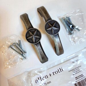 May include: Two matte pewter finish cabinet pulls with starburst medallions. Each pull is 3 inches (76 mm) long and includes mounting screws. The hardware is from the Allen + Roth brand.
