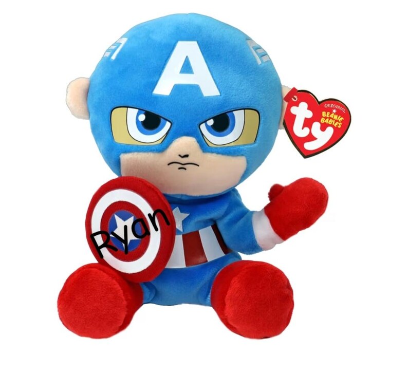 May include: A plush Captain America doll with a blue helmet featuring a white "A", and a red, white, and blue shield. The doll has red gloves and boots, and a "Ty Beanie Babies" tag.